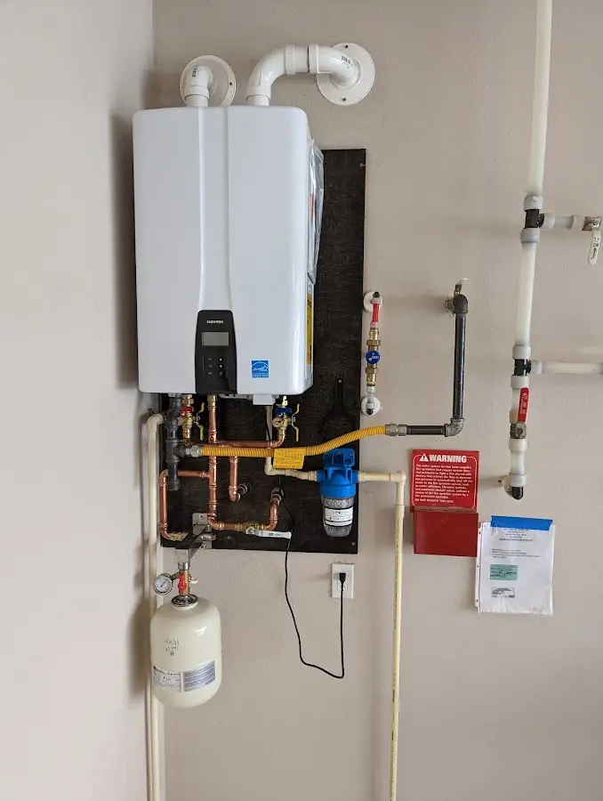 Professional plumber installing copper piping in a Galena home